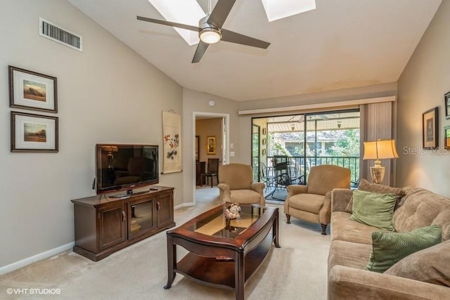 living room with vaulted ceiling, baseboards, visible vents, light colored carpet, and a ceiling fan