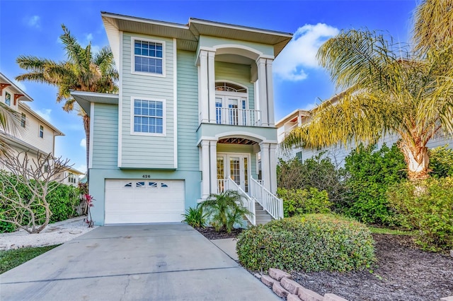 426 Magnolia Ave, Anna Maria, FL 34216 - beach home with french doors, an attached garage, a balcony, and driveway