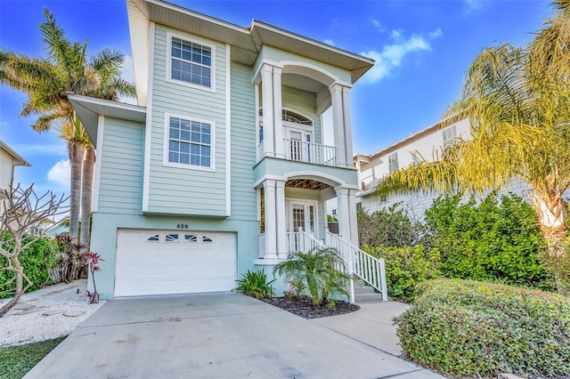 426 Magnolia Ave, Anna Maria, FL 34216 - view of front facade with an attached garage, driveway, a balcony, and stucco siding