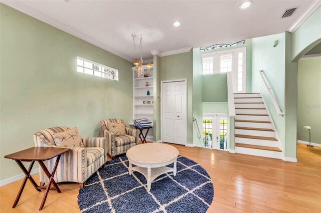 426 Magnolia Ave, Anna Maria, FL 34216 - living area featuring wood finished floors, stairs, baseboards, ornamental molding, and visible vents