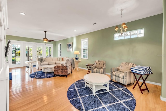 426 Magnolia Ave, Anna Maria, FL 34216 - living room with ceiling fan with notable chandelier, light wood-style flooring, baseboards, and recessed lighting