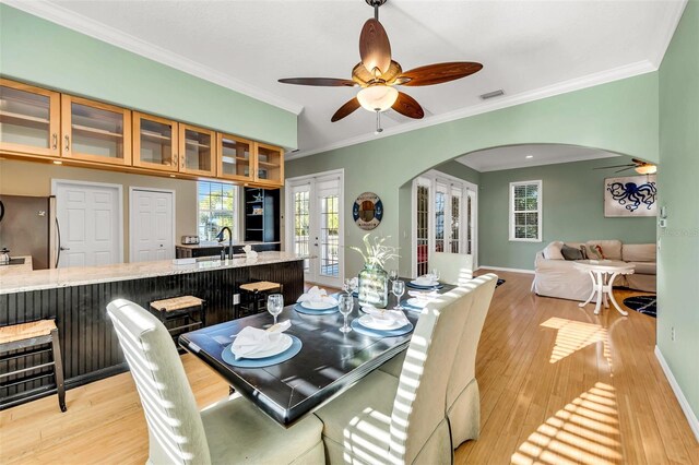 426 Magnolia Ave, Anna Maria, FL 34216 - dining space with arched walkways, a ceiling fan, visible vents, and light wood-type flooring