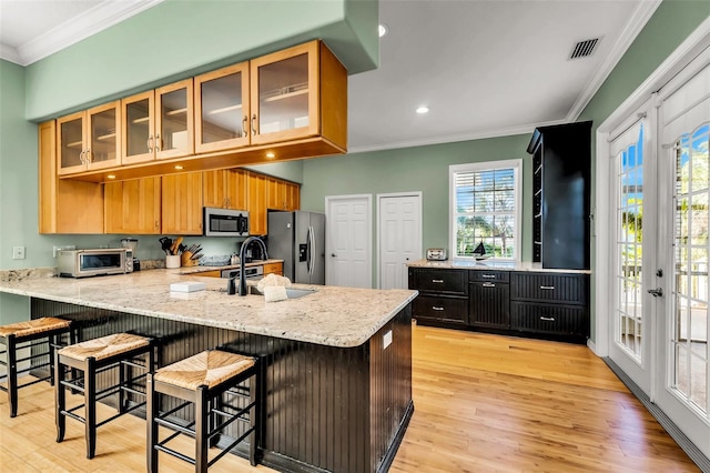 426 Magnolia Ave, Anna Maria, FL 34216 - kitchen with stainless steel appliances, a peninsula, visible vents, and crown molding