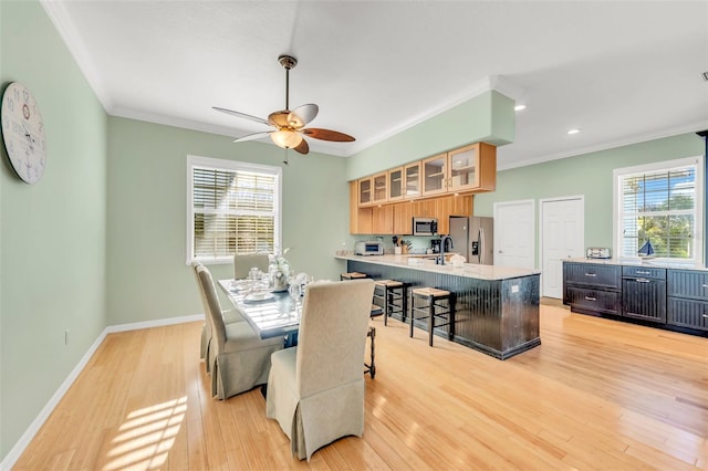 426 Magnolia Ave, Anna Maria, FL 34216 - dining room with ceiling fan, crown molding, light wood-style flooring, and plenty of natural light