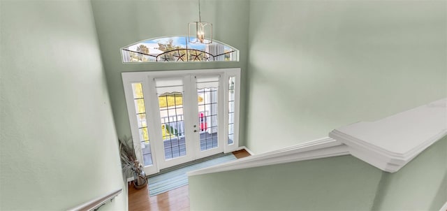 426 Magnolia Ave, Anna Maria, FL 34216 - entryway with a notable chandelier, french doors, and wood finished floors