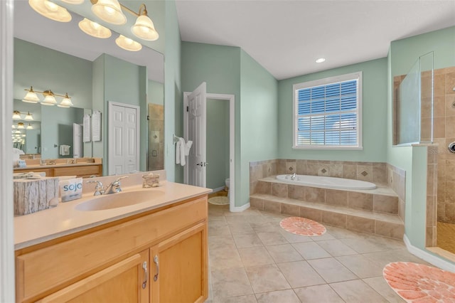 426 Magnolia Ave, Anna Maria, FL 34216 - bathroom featuring a garden tub, tile patterned floors, a stall shower, vanity, and toilet