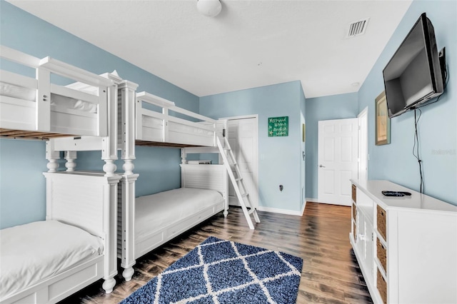 426 Magnolia Ave, Anna Maria, FL 34216 - bedroom with baseboards, wood finished floors, and visible vents