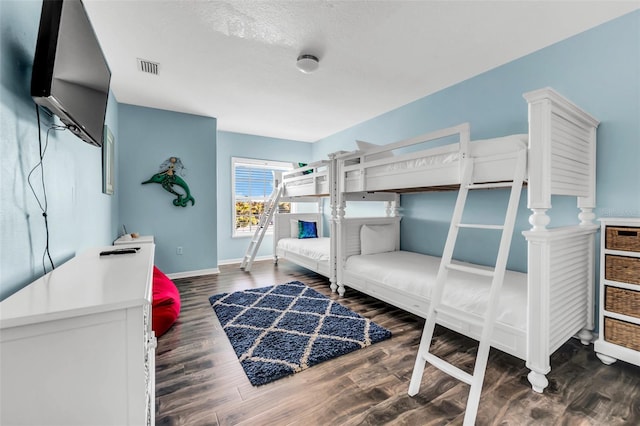 426 Magnolia Ave, Anna Maria, FL 34216 - bedroom with baseboards, wood finished floors, and visible vents