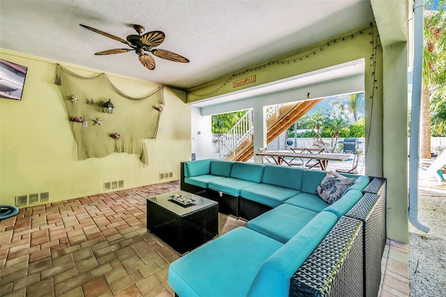 426 Magnolia Ave, Anna Maria, FL 34216 - living area featuring brick floor, visible vents, and a ceiling fan