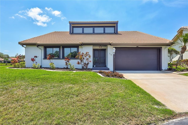 75 Inlets Blvd Unit 75, Nokomis, FL 34275 - view of front of property featuring stucco siding, an attached garage, a tile roof, and concrete driveway