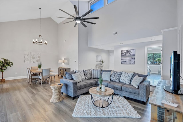 75 Inlets Blvd Unit 75, Nokomis, FL 34275 - living room featuring high vaulted ceiling, baseboards, wood finished floors, and visible vents