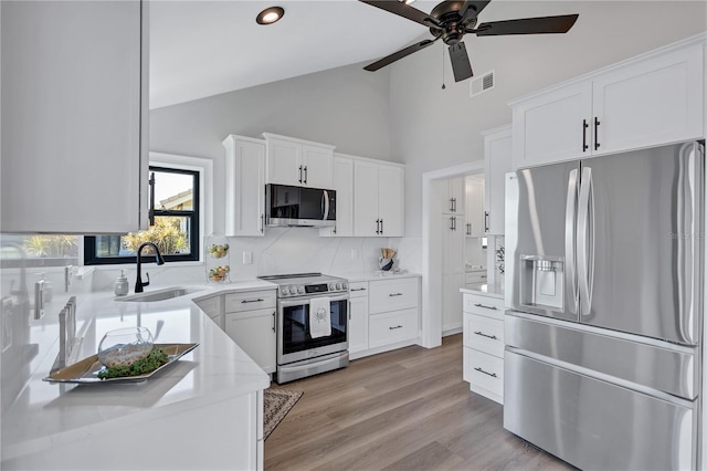 75 Inlets Blvd Unit 75, Nokomis, FL 34275 - kitchen with a sink, ceiling fan, backsplash, appliances with stainless steel finishes, and visible vents