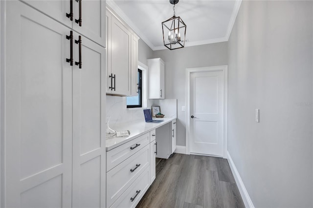 75 Inlets Blvd Unit 75, Nokomis, FL 34275 - interior space featuring baseboards, an inviting chandelier, ornamental molding, and dark wood-style flooring