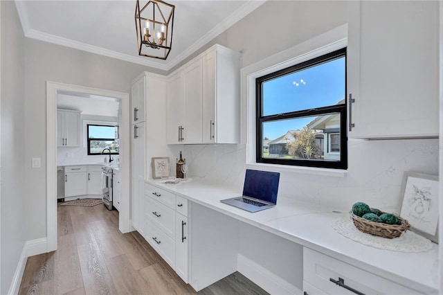 75 Inlets Blvd Unit 75, Nokomis, FL 34275 - office area with built in study area, crown molding, a notable chandelier, and wood finished floors