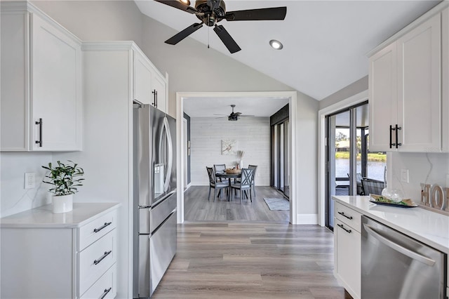 75 Inlets Blvd Unit 75, Nokomis, FL 34275 - kitchen with white cabinets, stainless steel appliances, vaulted ceiling, a ceiling fan, and light countertops