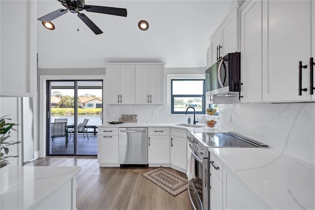 75 Inlets Blvd Unit 75, Nokomis, FL 34275 - kitchen featuring recessed lighting, white cabinets, stainless steel appliances, and a sink