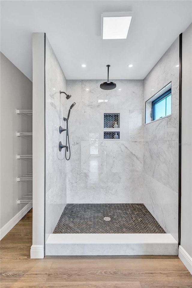 75 Inlets Blvd Unit 75, Nokomis, FL 34275 - bathroom with baseboards, wood finished floors, and a tile shower