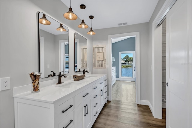 75 Inlets Blvd Unit 75, Nokomis, FL 34275 - full bathroom featuring double vanity, wood finished floors, visible vents, and a sink