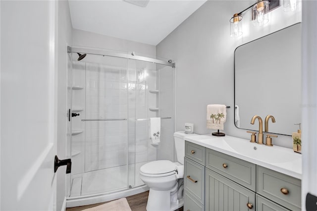 75 Inlets Blvd Unit 75, Nokomis, FL 34275 - bathroom with wood finished floors, vanity, toilet, and a stall shower