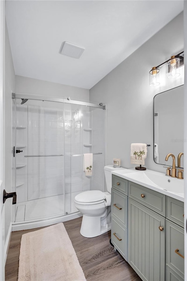 75 Inlets Blvd Unit 75, Nokomis, FL 34275 - bathroom with wood finished floors, visible vents, a shower stall, and toilet