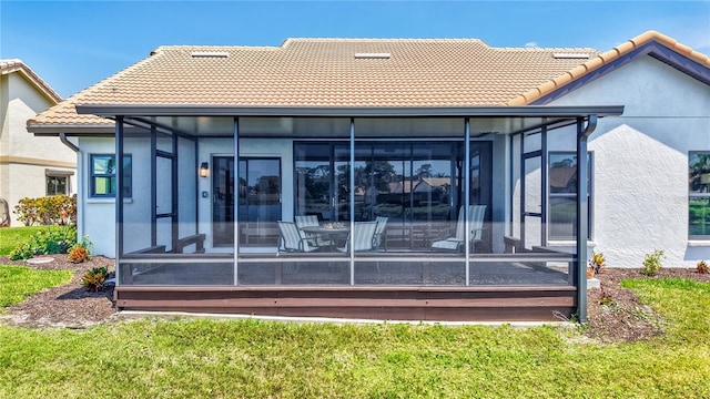 75 Inlets Blvd Unit 75, Nokomis, FL 34275 - back of property with stucco siding, a sunroom, and a tiled roof