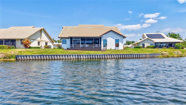 75 Inlets Blvd Unit 75, Nokomis, FL 34275 - rear view of property featuring stucco siding, a tile roof, a sunroom, and a water view