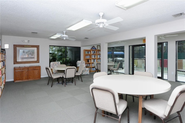 75 Inlets Blvd Unit 75, Nokomis, FL 34275 - dining space featuring a textured ceiling, visible vents, a ceiling fan, and baseboards