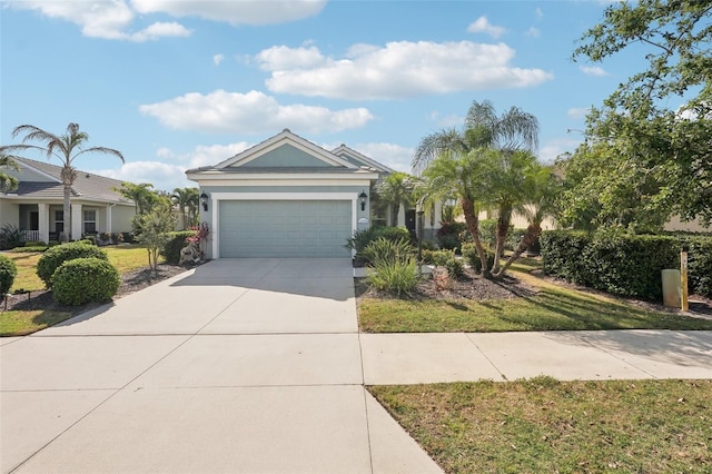 view of front of home with a front lawn, stucco siding, driveway, and an attached garage