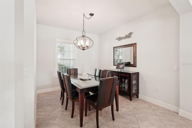dining room featuring light tile patterned flooring, a notable chandelier, and baseboards