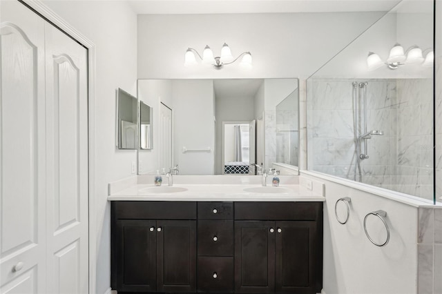bathroom with a walk in shower, double vanity, and a sink