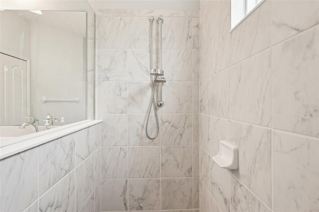 full bath featuring a tile shower