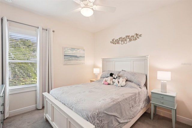 bedroom with baseboards, carpet floors, and multiple windows