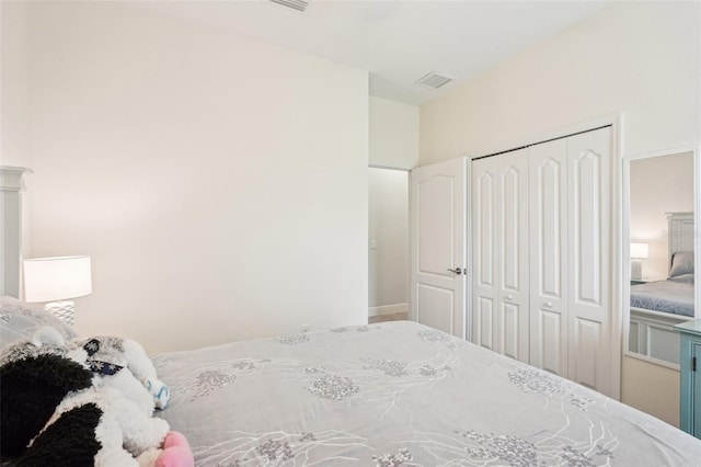 bedroom with visible vents and a closet