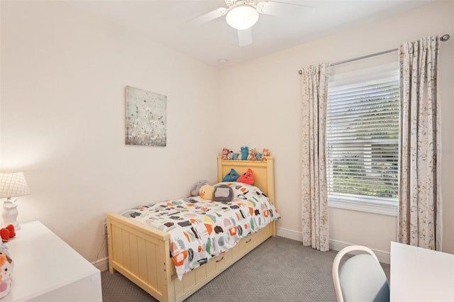 carpeted bedroom featuring ceiling fan and baseboards