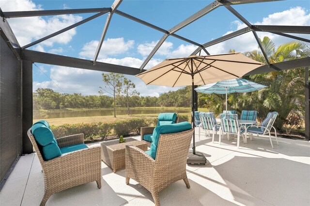 view of patio featuring outdoor lounge area, outdoor dining area, and glass enclosure