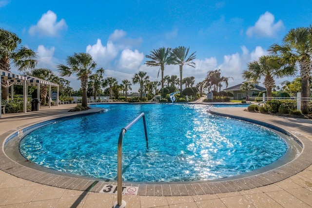 community pool featuring a water slide