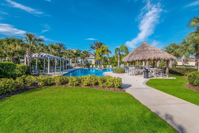 community pool featuring a lawn, a patio, and a gazebo