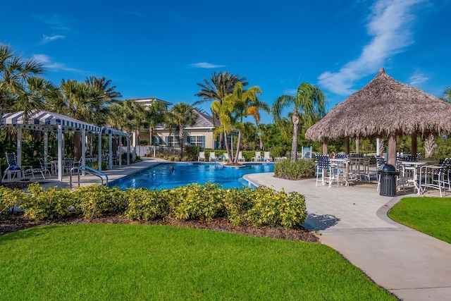 community pool with a lawn, a gazebo, and a patio