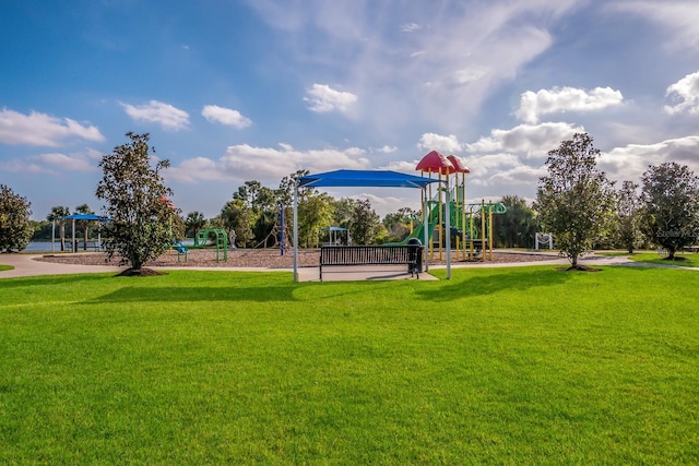 view of home's community with playground community and a yard