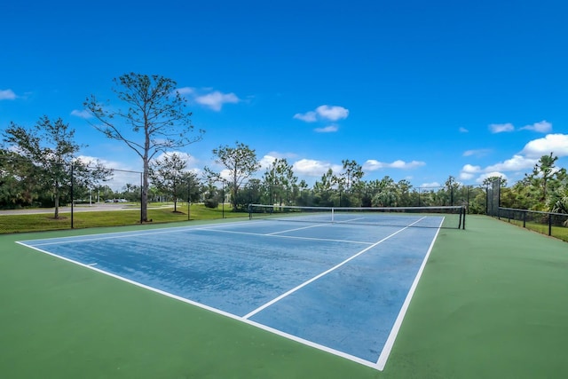 view of tennis court with fence