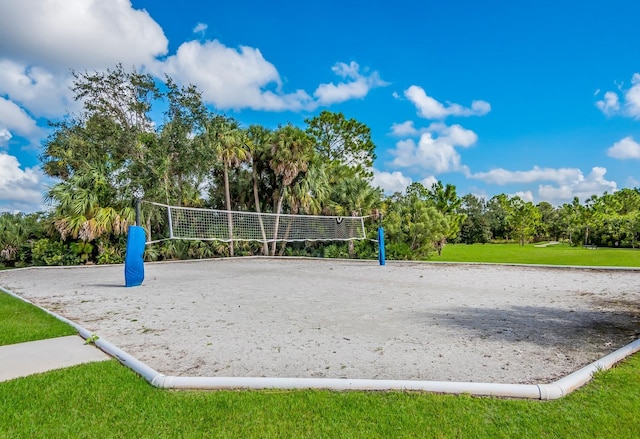 surrounding community featuring a lawn and volleyball court