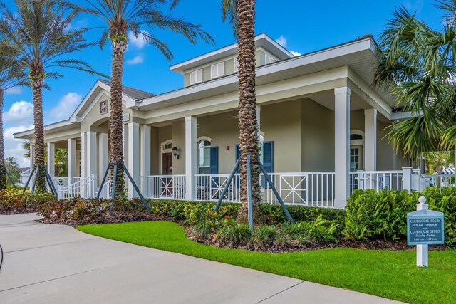 view of front of house with stucco siding and a porch