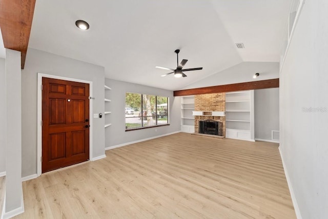 unfurnished living room with vaulted ceiling, a ceiling fan, light wood-type flooring, built in shelves, and baseboards
