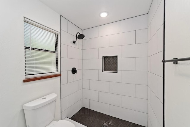full bath featuring toilet and tiled shower
