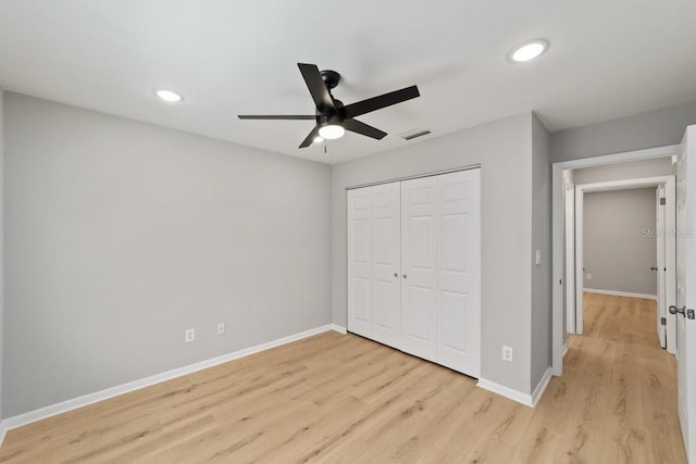 unfurnished bedroom with recessed lighting, visible vents, light wood-style floors, a closet, and baseboards