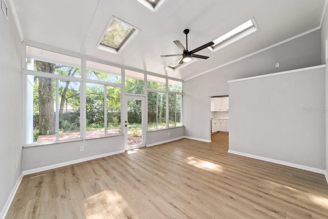 unfurnished living room featuring light wood finished floors, baseboards, a skylight, a ceiling fan, and high vaulted ceiling
