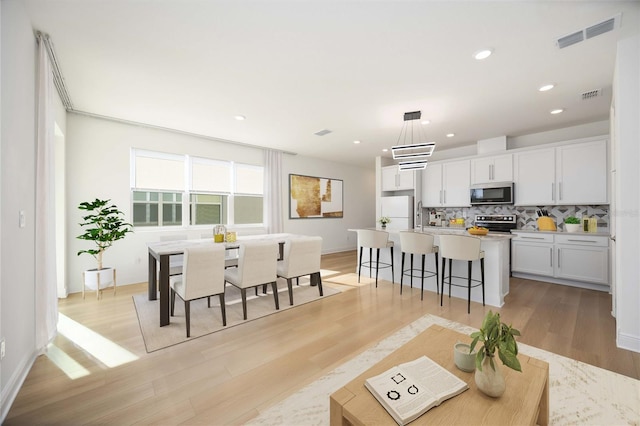 10455 Wet Marsh Cv, Parrish, FL 34219 - living room with light wood-style floors, recessed lighting, and baseboards