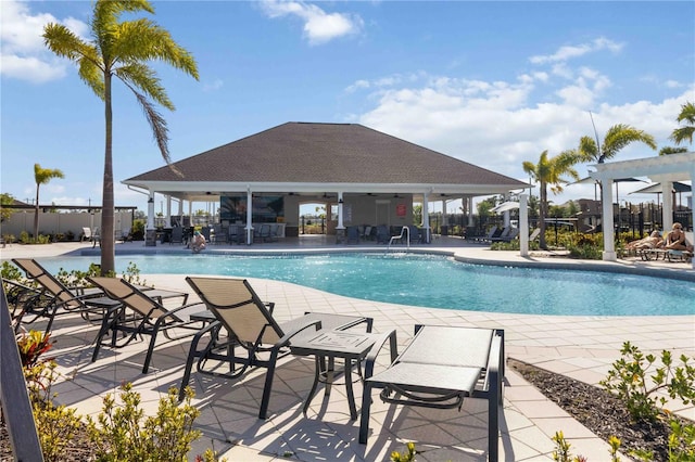 10455 Wet Marsh Cv, Parrish, FL 34219 - community pool with a ceiling fan and a patio area