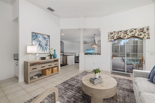9101 Yarberry St, Sarasota, FL 34240 - living area with ornate columns, ornamental molding, light tile patterned floors, and baseboards