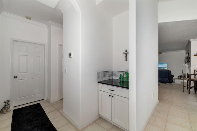 9101 Yarberry St, Sarasota, FL 34240 - corridor featuring ornamental molding, light tile patterned floors, and baseboards